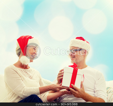 To use this stock image in your creative project, please select the size you need over to the right and click the "Add to Cart" button.
Your downloaded image will come with the Cutcaster watermark removed so don’t worry about the watermark you see on this page. happy senior couple with gift box at home stock photo, family, holidays, christmas, age and people concept - happy senior couple with gift box over blue lights background by Syda Productions