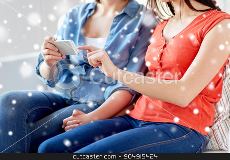 To use this stock image in your creative project, please select the size you need over to the right and click the "Add to Cart" button.
Your downloaded image will come with the Cutcaster watermark removed so don’t worry about the watermark you see on this page. close up of lesbian couple with smartphone at home stock photo, people, homosexuality, same-sex marriage, gay and love concept - close up of happy lesbian couple with smartphone at home over snow effect by Syda Productions