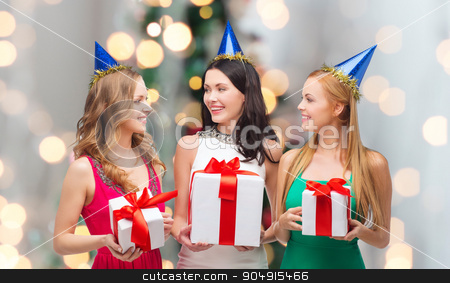 To use this stock image in your creative project, please select the size you need over to the right and click the "Add to Cart" button.
Your downloaded image will come with the Cutcaster watermark removed so don’t worry about the watermark you see on this page. smiling women in party caps with gift boxes stock photo, presents, holidays, people and celebration concept - smiling women in party caps with gift boxes over christmas tree lights background by Syda Productions
