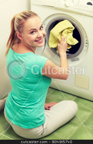 To use this stock image in your creative project, please select the size you need over to the right and click the "Add to Cart" button.
Your downloaded image will come with the Cutcaster watermark removed so don’t worry about the watermark you see on this page. happy woman putting laundry into washer at home stock photo, people, housework, laundry and housekeeping concept - happy woman putting laundry into washing machine at home by Syda Productions
