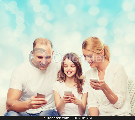 To use this stock image in your creative project, please select the size you need over to the right and click the "Add to Cart" button.
Your downloaded image will come with the Cutcaster watermark removed so don’t worry about the watermark you see on this page. happy family with smartphones stock photo, family, holidays, technology and people - smiling mother, father and little girl with smartphones over blue lights background by Syda Productions