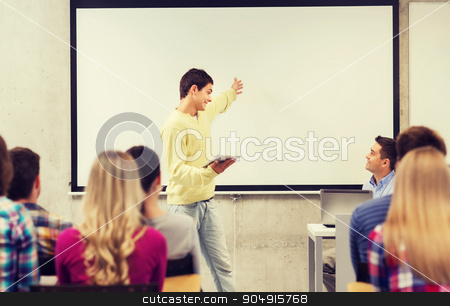 To use this stock image in your creative project, please select the size you need over to the right and click the "Add to Cart" button.
Your downloaded image will come with the Cutcaster watermark removed so don’t worry about the watermark you see on this page. group of smiling students and teacher in classroom stock photo, education, high school, technology and people concept - smiling student boy with tablet pc, laptop computer standing in front of students and teacher in classroom by Syda Productions