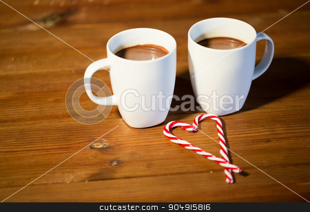 To use this stock image in your creative project, please select the size you need over to the right and click the "Add to Cart" button.
Your downloaded image will come with the Cutcaster watermark removed so don’t worry about the watermark you see on this page. christmas candy canes and cups on wooden table stock photo, holidays, christmas, winter, food and drinks concept - close up of candy canes and cups with hot chocolate or cocoa drinks on wooden table by Syda Productions