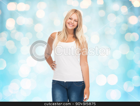 To use this stock image in your creative project, please select the size you need over to the right and click the "Add to Cart" button.
Your downloaded image will come with the Cutcaster watermark removed so don’t worry about the watermark you see on this page. smiling young woman in blank white shirt and jeans stock photo, people, holidays, style and body type concept - smiling young woman in blank white shirt and jeans over blue holidays lights background by Syda Productions