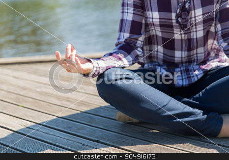 To use this stock image in your creative project, please select the size you need over to the right and click the "Add to Cart" button.
Your downloaded image will come with the Cutcaster watermark removed so don’t worry about the watermark you see on this page. close up of woman in yoga lotus pose outdoors stock photo, yoga, meditation, people and lifestyle concept - close up of woman meditating in lotus pose outdoors on berth by Syda Productions