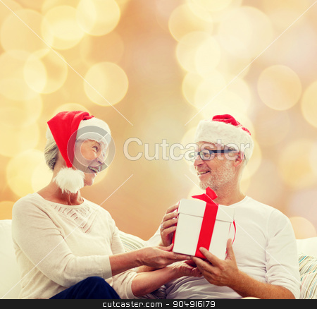 To use this stock image in your creative project, please select the size you need over to the right and click the "Add to Cart" button.
Your downloaded image will come with the Cutcaster watermark removed so don’t worry about the watermark you see on this page. happy senior couple with gift box at home stock photo, family, holidays, christmas, age and people concept - happy senior couple with gift box over beige lights background by Syda Productions