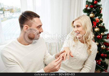 To use this stock image in your creative project, please select the size you need over to the right and click the "Add to Cart" button.
Your downloaded image will come with the Cutcaster watermark removed so don’t worry about the watermark you see on this page. man giving engagement ring to woman for christmas stock photo, love, christmas, couple, present and people concept - happy man giving engagement diamond ring to woman at home by Syda Productions