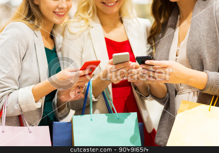 To use this stock image in your creative project, please select the size you need over to the right and click the "Add to Cart" button.
Your downloaded image will come with the Cutcaster watermark removed so don’t worry about the watermark you see on this page. happy women with smartphones and shopping bags stock photo, sale, consumerism, technology and people concept - happy young women with smartphones and shopping bags talking in mall by Syda Productions