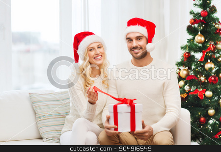 To use this stock image in your creative project, please select the size you need over to the right and click the "Add to Cart" button.
Your downloaded image will come with the Cutcaster watermark removed so don’t worry about the watermark you see on this page. happy couple at home with christmas gift box stock photo, christmas, holidays and people concept - happy couple in santa hats with gift box sitting on sofa at home by Syda Productions