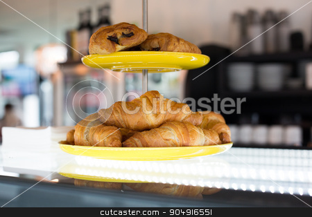 To use this stock image in your creative project, please select the size you need over to the right and click the "Add to Cart" button.
Your downloaded image will come with the Cutcaster watermark removed so don’t worry about the watermark you see on this page. close up of croissants and buns on cake stand stock photo, food, baking, junk-food and unhealthy eating concept - close up of croissants and buns on cake stand at cafe or bakery by Syda Productions