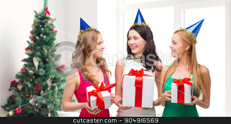 To use this stock image in your creative project, please select the size you need over to the right and click the "Add to Cart" button.
Your downloaded image will come with the Cutcaster watermark removed so don’t worry about the watermark you see on this page. smiling women in party caps with gift boxes stock photo, presents, holidays, people and celebration concept - smiling women in party caps with gift boxes over living room and christmas tree background by Syda Productions