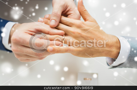 To use this stock image in your creative project, please select the size you need over to the right and click the "Add to Cart" button.
Your downloaded image will come with the Cutcaster watermark removed so don’t worry about the watermark you see on this page. close up of male gay couple hands and wedding ring stock photo, people, homosexuality, same-sex marriage and love concept - close up of happy male gay couple hands putting wedding ring on over snow effect by Syda Productions