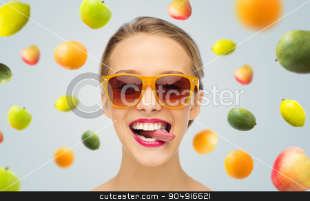 To use this stock image in your creative project, please select the size you need over to the right and click the "Add to Cart" button.
Your downloaded image will come with the Cutcaster watermark removed so don’t worry about the watermark you see on this page. happy young woman in sunglasses showing tongue stock photo, people, expression, joy and fashion concept - smiling young woman in sunglasses with pink lipstick on lips showing tongue by Syda Productions