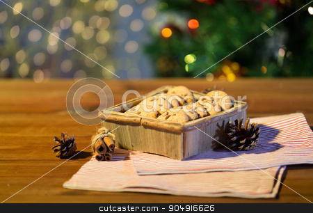 To use this stock image in your creative project, please select the size you need over to the right and click the "Add to Cart" button.
Your downloaded image will come with the Cutcaster watermark removed so don’t worry about the watermark you see on this page. close up of christmas oat cookies on wooden table stock photo, christmas, holidays, food and baking concept - close up of oat cookies in wooden box and cinnamon on table over lights by Syda Productions