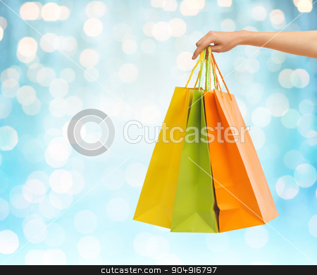 To use this stock image in your creative project, please select the size you need over to the right and click the "Add to Cart" button.
Your downloaded image will come with the Cutcaster watermark removed so don’t worry about the watermark you see on this page. close up of hand holding shopping bags stock photo, people, sale, consumerism and advertisement concept - close up of hand holding shopping bags over blue holidays lights background by Syda Productions