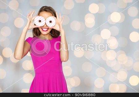 To use this stock image in your creative project, please select the size you need over to the right and click the "Add to Cart" button.
Your downloaded image will come with the Cutcaster watermark removed so don’t worry about the watermark you see on this page. happy woman or teen girl looking through donuts stock photo, people, holidays, junk food and fast food concept - happy young woman or teen girl in pink dress having fun and looking through donuts over lights background by Syda Productions
