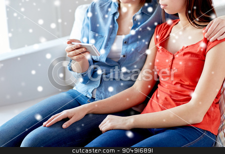 To use this stock image in your creative project, please select the size you need over to the right and click the "Add to Cart" button.
Your downloaded image will come with the Cutcaster watermark removed so don’t worry about the watermark you see on this page. close up of lesbian couple with smartphone at home stock photo, people, homosexuality, same-sex marriage, gay and love concept - close up of happy lesbian couple with smartphone at home over snow effect by Syda Productions