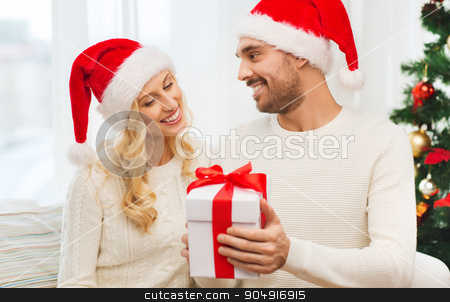 To use this stock image in your creative project, please select the size you need over to the right and click the "Add to Cart" button.
Your downloaded image will come with the Cutcaster watermark removed so don’t worry about the watermark you see on this page. happy couple at home with christmas gift box stock photo, christmas, holidays and people concept - happy couple in santa hats with gift box sitting on sofa at home by Syda Productions