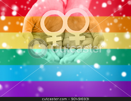 To use this stock image in your creative project, please select the size you need over to the right and click the "Add to Cart" button.
Your downloaded image will come with the Cutcaster watermark removed so don’t worry about the watermark you see on this page. close up of lesbian couple hands with venus symbol stock photo, people, homosexuality, same-sex marriage, gay pride and love concept - close up of happy lesbian couple hands holding white paper venus symbol over rainbow flag stripes background over snow effect by Syda Productions
