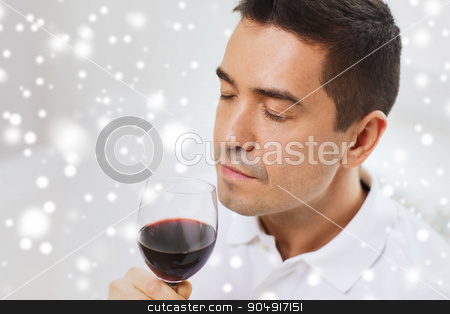 To use this stock image in your creative project, please select the size you need over to the right and click the "Add to Cart" button.
Your downloaded image will come with the Cutcaster watermark removed so don’t worry about the watermark you see on this page. happy man drinking red wine from glass at home stock photo, profession, drinks, leisure and people concept - happy man drinking and smelling red wine from glass over snow effect by Syda Productions