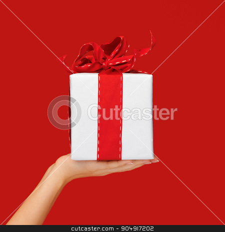 To use this stock image in your creative project, please select the size you need over to the right and click the "Add to Cart" button.
Your downloaded image will come with the Cutcaster watermark removed so don’t worry about the watermark you see on this page. close up hand holding christmas gift box over red stock photo, people, holidays, present, surprise and birthday concept - close up hand holding christmas gift box over red background by Syda Productions
