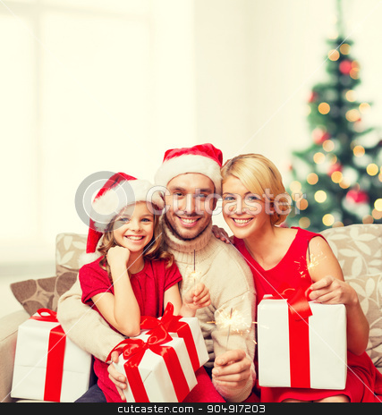 To use this stock image in your creative project, please select the size you need over to the right and click the "Add to Cart" button.
Your downloaded image will come with the Cutcaster watermark removed so don’t worry about the watermark you see on this page. smiling family holding gift boxes and sparkles stock photo, family, christmas, x-mas, happiness and people concept - smiling family in santa helper hats with many gift boxes and bengal lights by Syda Productions