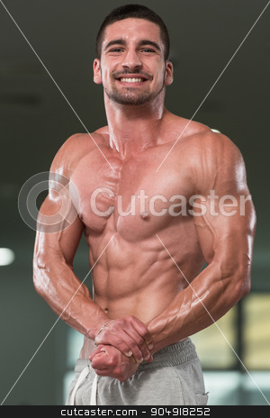To use this stock image in your creative project, please select the size you need over to the right and click the "Add to Cart" button.
Your downloaded image will come with the Cutcaster watermark removed so don’t worry about the watermark you see on this page. Portrait Of A Physically Fit Muscular Young Man stock photo, Awesome Bodybuilder Showing His Muscles And Posing In Gym by Jasminko Ibrakovic