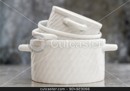 To use this stock image in your creative project, please select the size you need over to the right and click the "Add to Cart" button.
Your downloaded image will come with the Cutcaster watermark removed so don’t worry about the watermark you see on this page. Empty White Porcelain Saucepans Without Covers stock photo, Empty white porcelain saucepans without covers on gray background by OZMedia