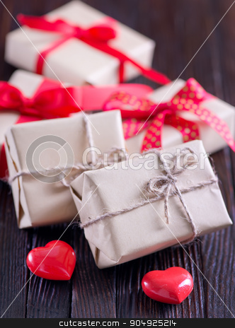 To use this stock image in your creative project, please select the size you need over to the right and click the "Add to Cart" button.
Your downloaded image will come with the Cutcaster watermark removed so don’t worry about the watermark you see on this page. presents stock photo, box for present with red ribbon on the wooden table by tycoon