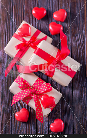 To use this stock image in your creative project, please select the size you need over to the right and click the "Add to Cart" button.
Your downloaded image will come with the Cutcaster watermark removed so don’t worry about the watermark you see on this page. presents stock photo, box for present with red ribbon on the wooden table by tycoon
