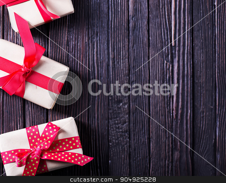 To use this stock image in your creative project, please select the size you need over to the right and click the "Add to Cart" button.
Your downloaded image will come with the Cutcaster watermark removed so don’t worry about the watermark you see on this page. presents stock photo, box for present with red ribbon on the wooden table by tycoon