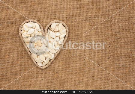 To use this stock image in your creative project, please select the size you need over to the right and click the "Add to Cart" button.
Your downloaded image will come with the Cutcaster watermark removed so don’t worry about the watermark you see on this page. Heart made from rope with pumpkin seeds lying on sackcloth stock photo, Heart made from rope with pumpkin seeds lying on sackcloth, with space for text by alekleks