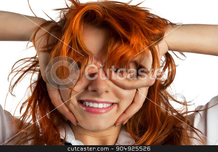To use this stock image in your creative project, please select the size you need over to the right and click the "Add to Cart" button.
Your downloaded image will come with the Cutcaster watermark removed so don’t worry about the watermark you see on this page. Red-haired girl makes out of its hands symbolic glasses stock photo, Red-haired girl makes out of its hands symbolic glasses, isolated on white background by alekleks