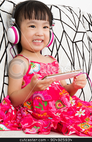 To use this stock image in your creative project, please select the size you need over to the right and click the "Add to Cart" button.
Your downloaded image will come with the Cutcaster watermark removed so don’t worry about the watermark you see on this page. Chinese little girl on headphones holding mobile phone stock photo, Chinese little girl on headphones holding mobile phone sitting on sofa by Tan Kian Khoon