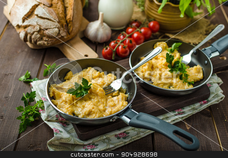 To use this stock image in your creative project, please select the size you need over to the right and click the "Add to Cart" button.
Your downloaded image will come with the Cutcaster watermark removed so don’t worry about the watermark you see on this page. Scrambled eggs with herbs and homemade bread stock photo, Scrambled eggs with herbs and homemade bread, on two frying pans by Peteer