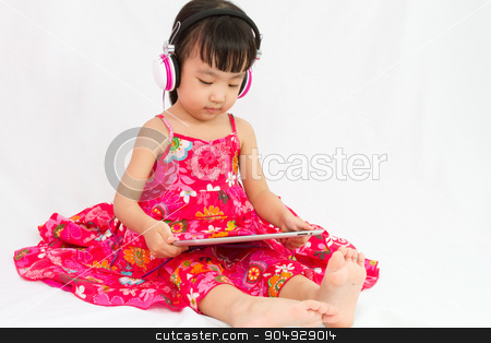 To use this stock image in your creative project, please select the size you need over to the right and click the "Add to Cart" button.
Your downloaded image will come with the Cutcaster watermark removed so don’t worry about the watermark you see on this page. Chinese little girl on headphones holding tablet stock photo, Chinese little girl on headphones holding tablet in plain isolated white background. by Tan Kian Khoon