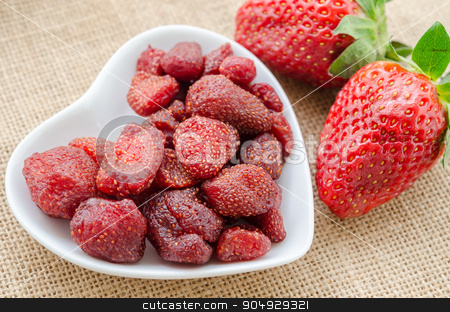To use this stock image in your creative project, please select the size you need over to the right and click the "Add to Cart" button.
Your downloaded image will come with the Cutcaster watermark removed so don’t worry about the watermark you see on this page. Dried strawberries and fresh strawberries stock photo, Dried strawberries in heart shape bowl with fresh strawberries on sack background. by Miss. PENCHAN PUMILA