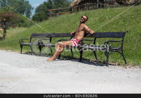 To use this stock image in your creative project, please select the size you need over to the right and click the "Add to Cart" button.
Your downloaded image will come with the Cutcaster watermark removed so don’t worry about the watermark you see on this page. Smiling Handsome Guy Resting On Bench Outdoors stock photo, Smiling Athlete With Naked Torso Sitting And Resting On Bench by Jasminko Ibrakovic