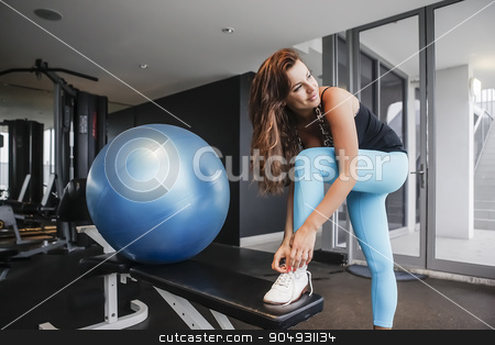 To use this stock image in your creative project, please select the size you need over to the right and click the "Add to Cart" button.
Your downloaded image will come with the Cutcaster watermark removed so don’t worry about the watermark you see on this page. Attractive girl tying her shoelaces in a gym stock photo, Attractive girl in yoga pants tying her shoelaces in a gym by JRstock