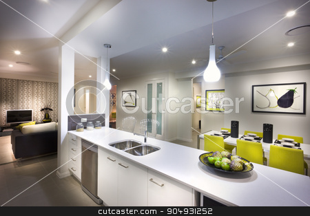 To use this stock image in your creative project, please select the size you need over to the right and click the "Add to Cart" button.
Your downloaded image will come with the Cutcaster watermark removed so don’t worry about the watermark you see on this page. A moody,stylish and beautiful image of a house with kitchen and stock photo, A moody and stylish image of a house with kitchen and attached living room and food placed on kitchen shelf by JRstock