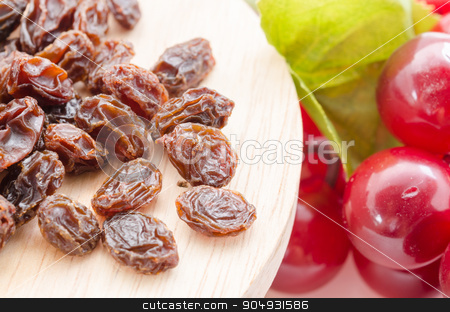 To use this stock image in your creative project, please select the size you need over to the right and click the "Add to Cart" button.
Your downloaded image will come with the Cutcaster watermark removed so don’t worry about the watermark you see on this page. Raisins stock photo, Raisins in wood with red grapes on table close up by Miss. PENCHAN PUMILA