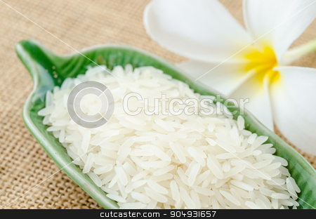 To use this stock image in your creative project, please select the size you need over to the right and click the "Add to Cart" button.
Your downloaded image will come with the Cutcaster watermark removed so don’t worry about the watermark you see on this page. Raw white rice. stock photo, Raw white rice in green cup with flower on sack background. by Miss. PENCHAN PUMILA