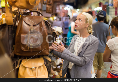 To use this stock image in your creative project, please select the size you need over to the right and click the "Add to Cart" button.
Your downloaded image will come with the Cutcaster watermark removed so don’t worry about the watermark you see on this page. Casual blond woman shopping for leather bag. stock photo, Beautiful casually dressed caucasian blond woman shopping for new leather bag on crafts market in Chania, Crete, Greece. by kasto