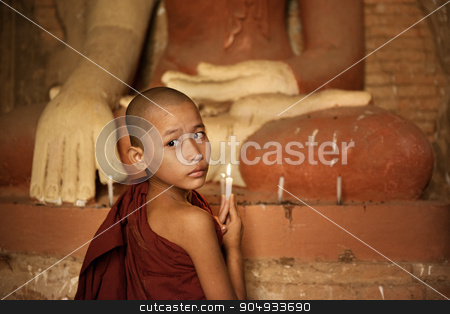 To use this stock image in your creative project, please select the size you need over to the right and click the "Add to Cart" button.
Your downloaded image will come with the Cutcaster watermark removed so don’t worry about the watermark you see on this page. Buddhist novices lighting up candlelight in temple stock photo, Portrait of young novice monk praying with candle light inside a Buddhist temple, Bagan, Myanmar. by szefei