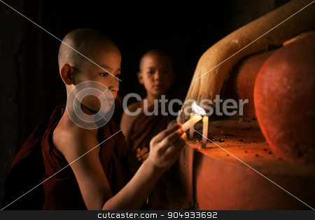 To use this stock image in your creative project, please select the size you need over to the right and click the "Add to Cart" button.
Your downloaded image will come with the Cutcaster watermark removed so don’t worry about the watermark you see on this page. Buddhist novices praying with candlelight in monastery stock photo, Portrait of young novice monks lighting up candlelight inside a Buddhist temple, low light setting, Bagan, Myanmar. by szefei