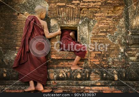 To use this stock image in your creative project, please select the size you need over to the right and click the "Add to Cart" button.
Your downloaded image will come with the Cutcaster watermark removed so don’t worry about the watermark you see on this page. Playful young novice monks stock photo, Two playful young novice monks climbing into Buddhist temple from window, Bagan, Myanmar. by szefei