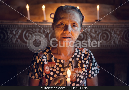 To use this stock image in your creative project, please select the size you need over to the right and click the "Add to Cart" button.
Your downloaded image will come with the Cutcaster watermark removed so don’t worry about the watermark you see on this page. Old Burmese woman stock photo, Old wrinkled traditional Asian woman praying with candle light inside a temple, low light, Myanmar by szefei
