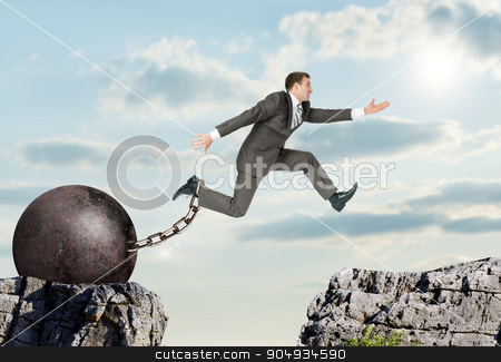To use this stock image in your creative project, please select the size you need over to the right and click the "Add to Cart" button.
Your downloaded image will come with the Cutcaster watermark removed so don’t worry about the watermark you see on this page. Image of young businessman jumping over gap stock photo, Image of young businessman with iron ballast jumping over gap by cherezoff