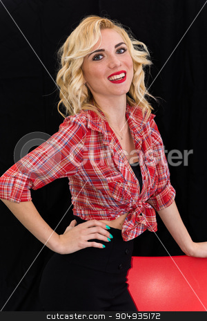 To use this stock image in your creative project, please select the size you need over to the right and click the "Add to Cart" button.
Your downloaded image will come with the Cutcaster watermark removed so don’t worry about the watermark you see on this page. Young girl, pin up typical American. stock photo, Young girl, pin up typical American. With pants or leggings and long blacks, on a black background, red and white checkered shirt, knotted navel, features dazzling smile. by GCammarata