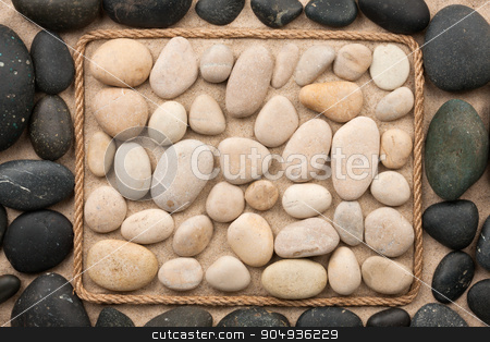 To use this stock image in your creative project, please select the size you need over to the right and click the "Add to Cart" button.
Your downloaded image will come with the Cutcaster watermark removed so don’t worry about the watermark you see on this page. Beautiful frame made of rope with black and white stones on the stock photo, Beautiful frame made of rope with black and white stones on the sand, as background by alekleks
